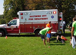 [photo, Fire Department personnel assisting injured football player, Patterson Park, Baltimore, Maryland]